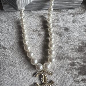 Elegant pearl necklace with a Chanel logo pendant.